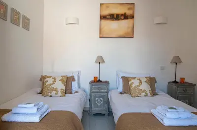 a bedroom with two beds with towels on them at La Marisol in LʼIsle-sur-la-Sorgue