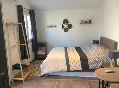 a bedroom with a bed and a ladder and a table at Ogooué Studio in Carpentras
