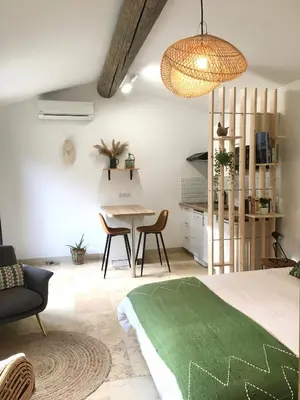a bedroom with a bed and a table and chairs at Mazet LEAJO in Eygalières