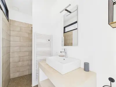a white bathroom with a sink and a mirror at Magnifique Mas Provençal avec Piscine à Eygalières - 19 Couchages, 8 Chambres, Billard, et Plus ! - FR-1-599-3 in Eygalières