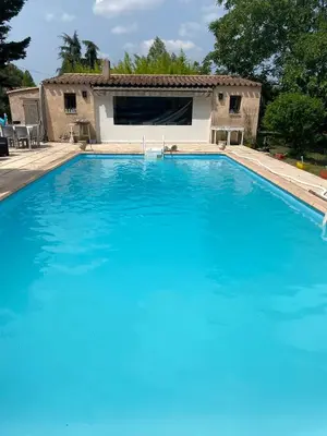 a large blue swimming pool in front of a house at « CARPE DIEM » in Aix-en-Provence