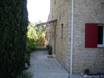 a door in the side of a stone building at La bastide de Mauragne - Gîte les Iris in Apt