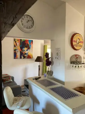 a living room with a couch and a table at La bastide de Mauragne - Gîte les Iris in Apt