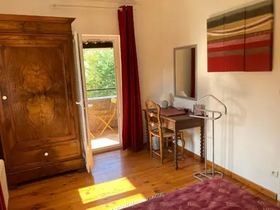 a view of a table and chairs from a window at La bastide de Mauragne - Gîte les Iris in Apt