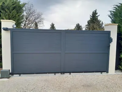 a black garage door in a driveway at Villa au pied du Ventoux in Mormoiron