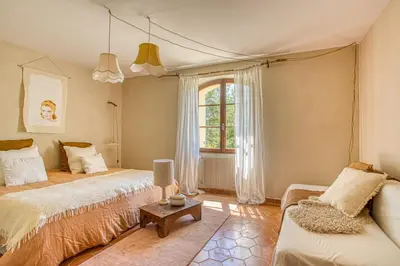 a bedroom with two beds and a couch at Mas de Bacalan in Mormoiron