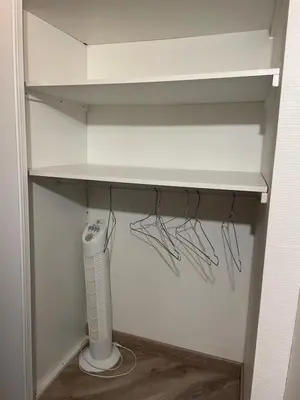 a closet with a shelf with a fan and a router at Studio cosy dans le centre-ville historique in LʼIsle-sur-la-Sorgue