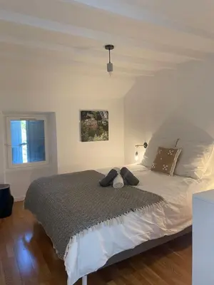 a bedroom with a large bed and a window at VILLA BEL - Entre paradis et vignes in Ménerbes