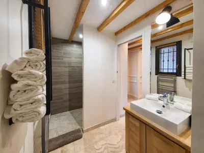 a bathroom with a sink and a towel pile at Le Vallon des Pins in La Cride