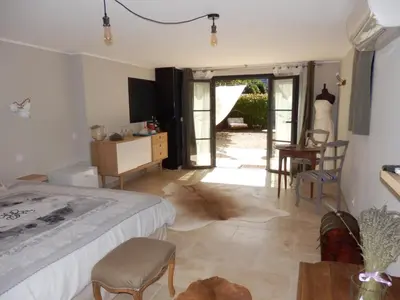 a bedroom with a bed and a table and chairs at La secrète chambre de la tour in Orgon