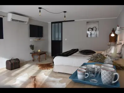 a room with a bed and a table with a tray at La secrète chambre de la tour in Orgon