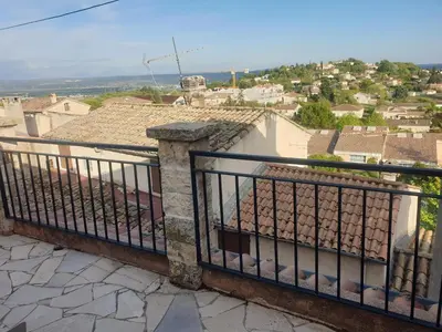 a balcony with a view of a city at Charmante maison de village au cœur du Luberon in Pierrevert