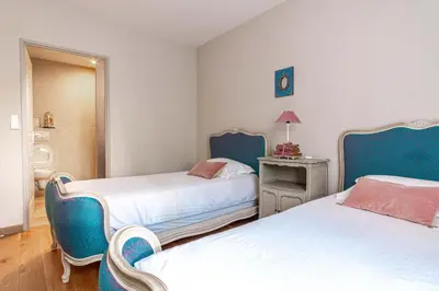 two beds in a room with blue and white at La Verdière - Contemporary house with garden and private pool in LʼIsle-sur-la-Sorgue