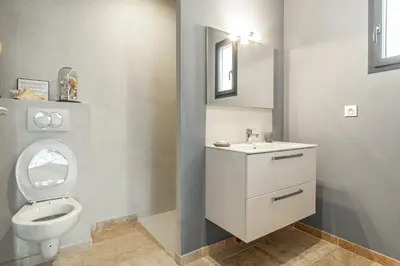 a bathroom with a toilet and a sink at La Verdière - Contemporary house with garden and private pool in LʼIsle-sur-la-Sorgue