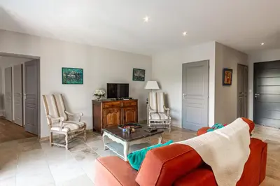 a living room with a couch and a table at La Verdière - Contemporary house with garden and private pool in LʼIsle-sur-la-Sorgue
