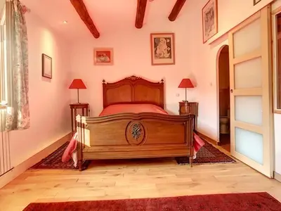 a bedroom with a wooden bed in a room at LesArnauds in Aix-en-Provence