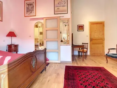 a bedroom with a bed and a room with a table at LesArnauds in Aix-en-Provence