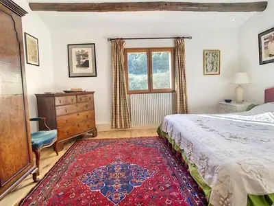 a bedroom with a bed and a dresser and a window at LesArnauds in Aix-en-Provence