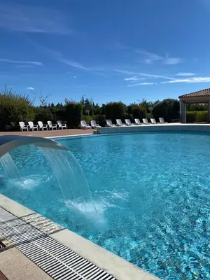 a swimming pool with a water fountain at Les Demeures du Ventoux in Aubignan
