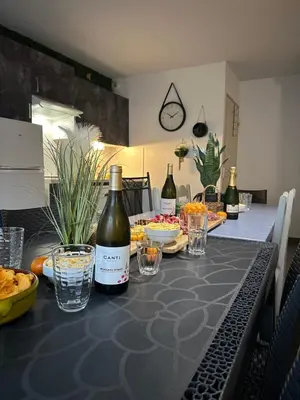 a kitchen with two bottles of wine on a table at Les Demeures du Ventoux in Aubignan
