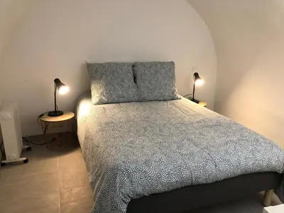 a bedroom with a bed with two pillows on it at Les Olives Wifi Netflix Appart-hotel-Provence in La Fare-les-Oliviers