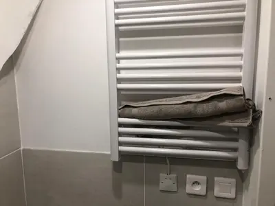a towel rack in a bathroom with a towel at Les Olives Wifi Netflix Appart-hotel-Provence in La Fare-les-Oliviers