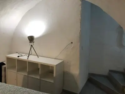 a lamp sitting on a white shelf in a room at Les Olives Wifi Netflix Appart-hotel-Provence in La Fare-les-Oliviers