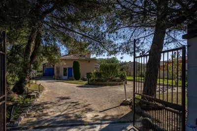 a gate to a house with a driveway at La Rose Des Vents in Modène