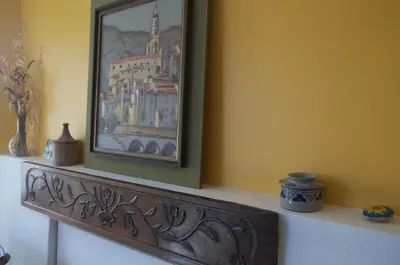 a painting on a wall above a mantle with a picture at Le petit Bacalan in Mormoiron