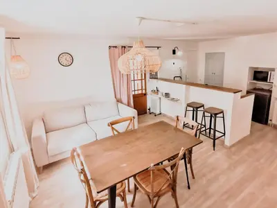 a living room with a table and chairs and a couch at La Source in Oppedette