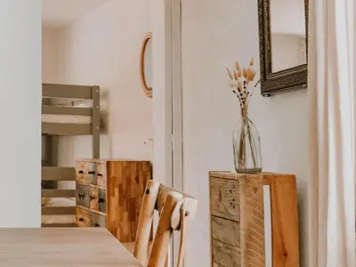 a dining room with a table and chairs and a vase with flowers at La Source in Oppedette