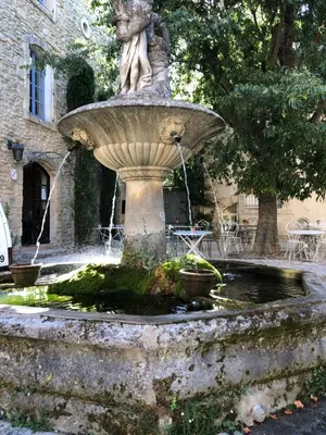 a statue of a woman sitting in a fountain at Studio 57 à Saignon in Saignon
