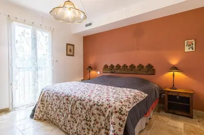 a bedroom with a bed and a large window at Stunning house on the edge of the Luberon in Cheval-Blanc