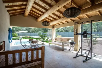 a patio with a bench and a table and chairs at Stunning house on the edge of the Luberon in Cheval-Blanc