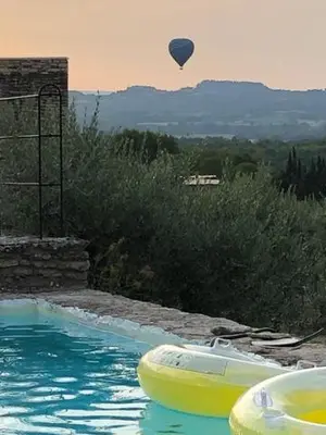 a hot air balloon flying over a swimming pool at Les Milles Roches in Gordes