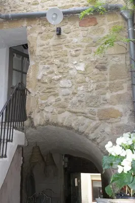 an entrance to a building with a stone wall at LE PASSAGE in Lourmarin