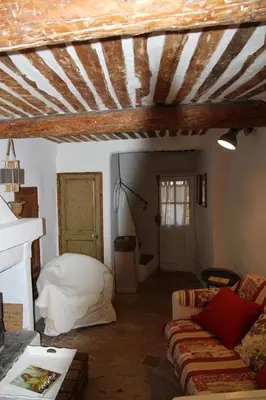 a living room with a couch and a bed at LE PASSAGE in Lourmarin