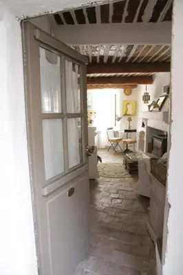 a door leading into a room with a kitchen at LE PASSAGE in Lourmarin