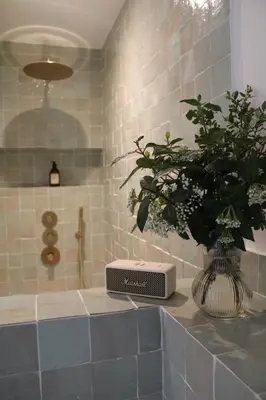 a bathroom with a sink with a vase of flowers at Maison Les Chênes in Eygalières