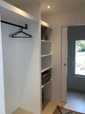 a room with a wall with shelves and a window at Maison Les Chênes in Eygalières