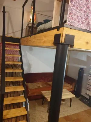 a bunk bed with a staircase in a room at Charmant appartement cœur village provençal in Lambesc