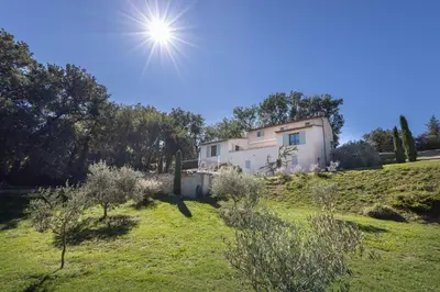a house on a hill with the sun in the sky at La Bastide des Milles in Apt