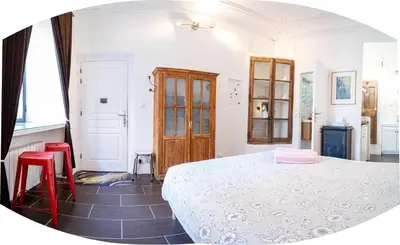 a kitchen with a sink and a wooden door at Le petit carnot in Apt