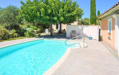 a swimming pool in a yard with a house at Nice Apartment In Caumont-Sur-Durance in Caumont-sur-Durance