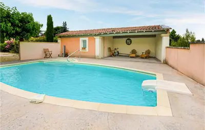 a swimming pool in front of a house at Nice Apartment In Caumont-Sur-Durance in Caumont-sur-Durance