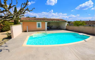 a swimming pool in front of a house at Nice Apartment In Caumont-Sur-Durance in Caumont-sur-Durance