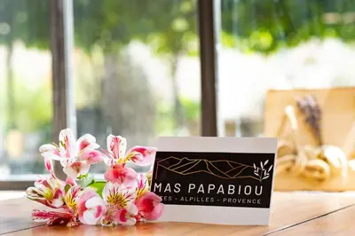a sign sitting on top of a table with flowers at MAS PAPABIOU in Eygalières
