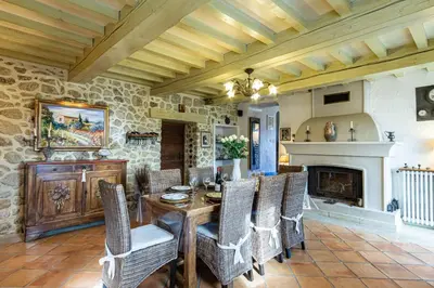 a dining room with a table and chairs and a fireplace at Stunning property between Alpilles and Luberon in Cavaillon
