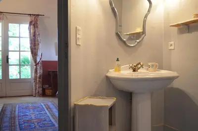 a bathroom with a white sink and a window at Le Mas Perréal in Saint-Saturnin-les-Apt