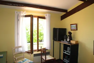 a living room with a window and a television at Chambres d'hôtes Elisa & Etienne in Manosque